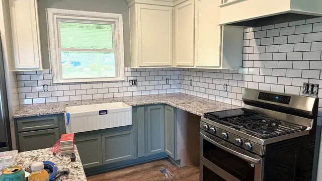 Kitchen remodel with subway tile backsplash, updated cabinets, countertops, and flooring