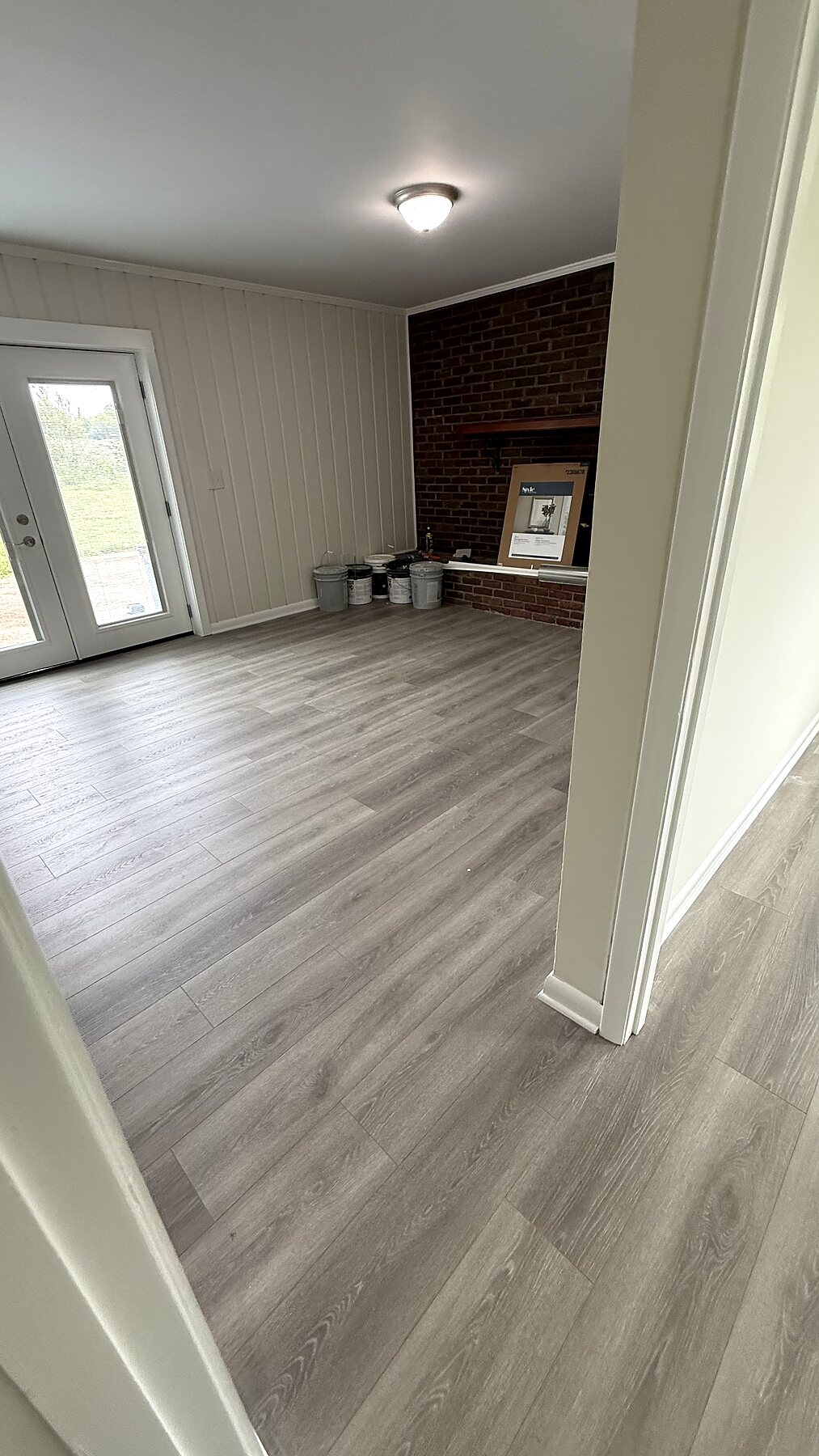 Luxury vinyl plank flooring installation in a living room by Grain and Stain Renovations in Hendersonville TN